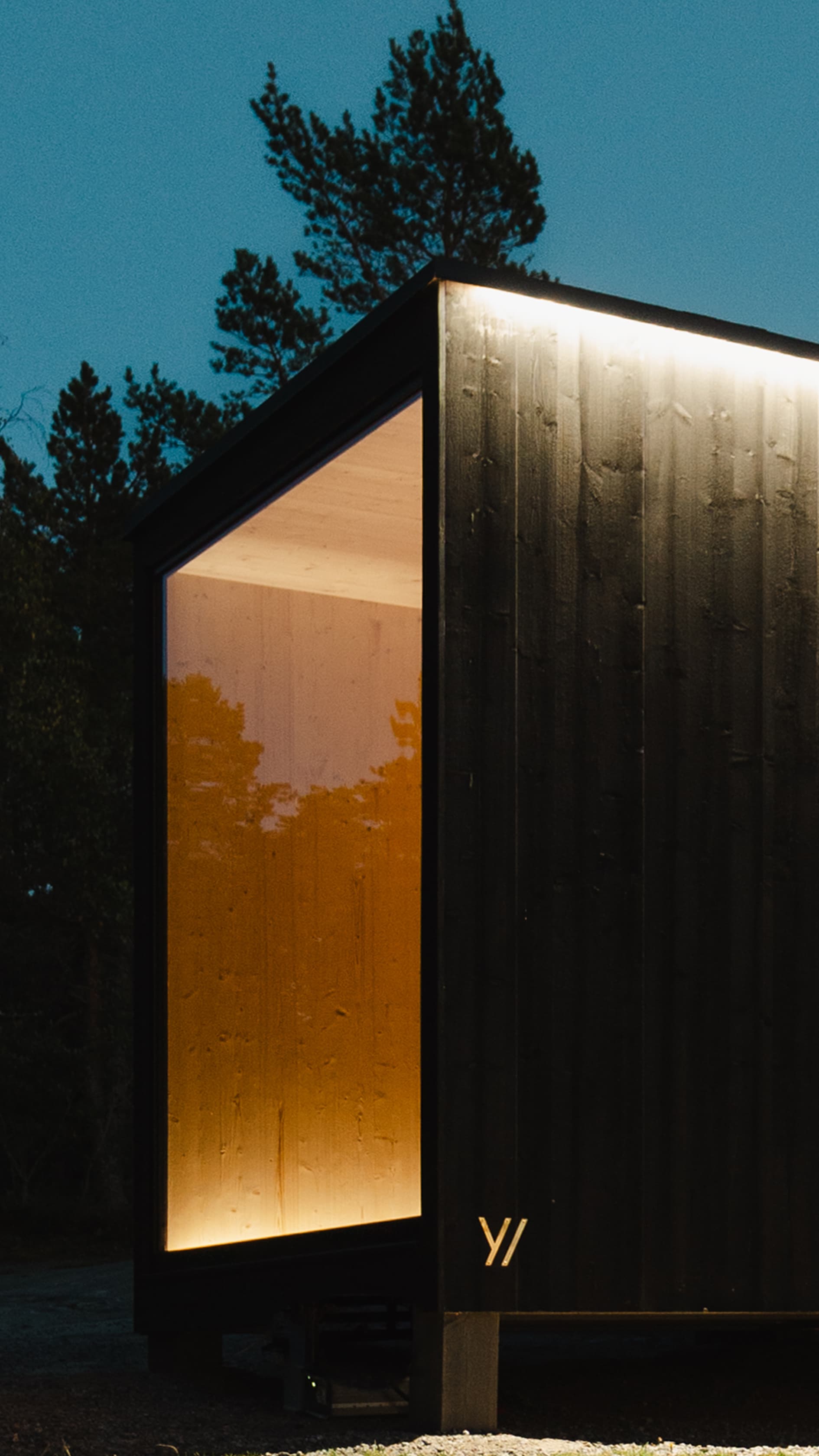 A modern hotel with a wooden facade in the mountains