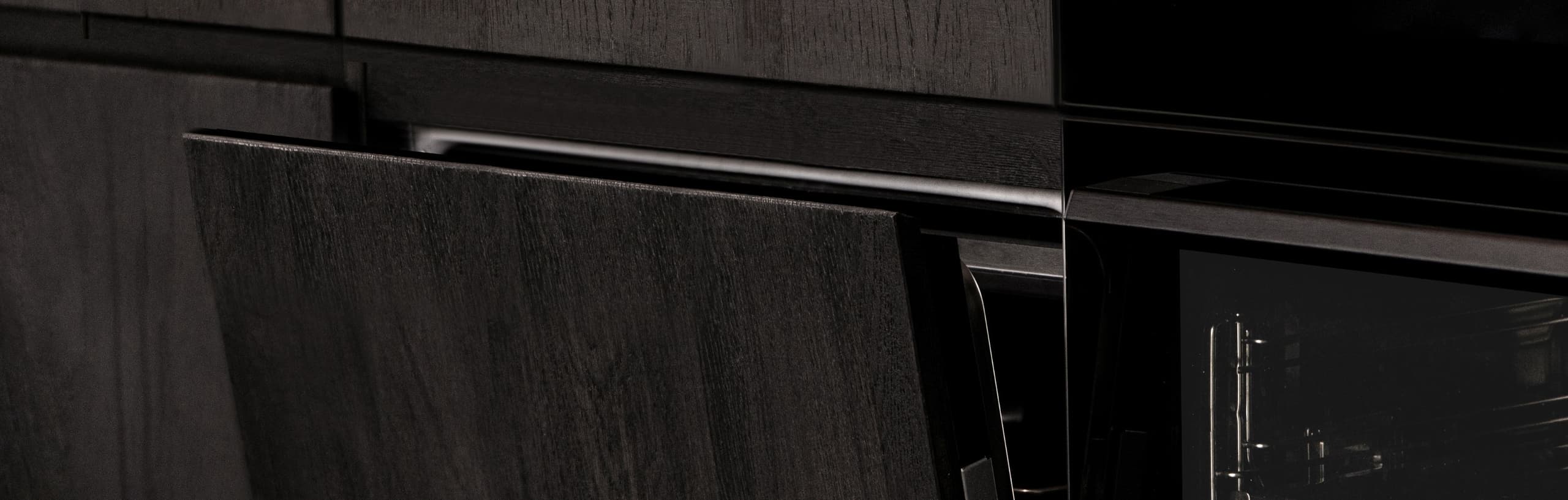 Dark kitchen cabinetry with devices integrated into the home system.
